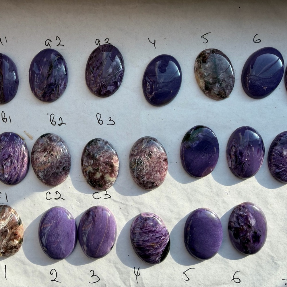 The set of two natural purple Charoite crystal gemstones